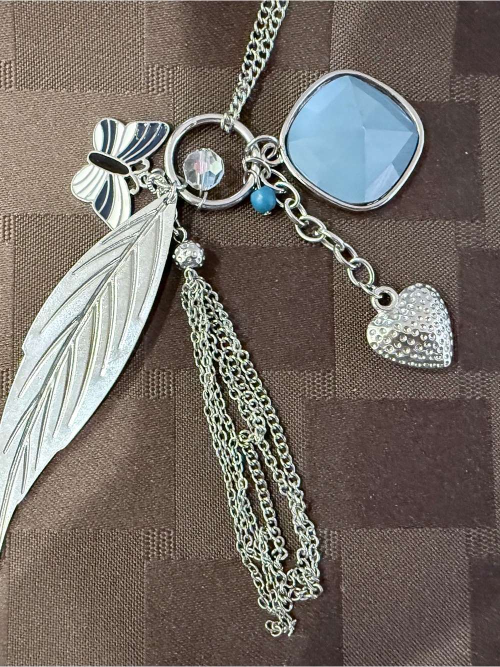 Silver Feather Pendant Necklace with Blue Faceted Stone and Heart Charm